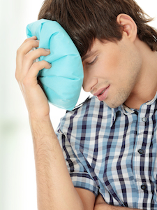 Man with ice bag for headaches, migraines ,hangover and injury